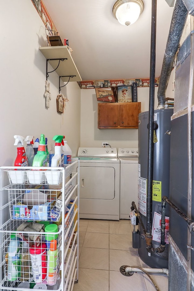 1456 Bangor Ln, Aurora, IL 60504 - laundry area with washing machine and clothes dryer, water heater, light tile patterned flooring, and cabinet space