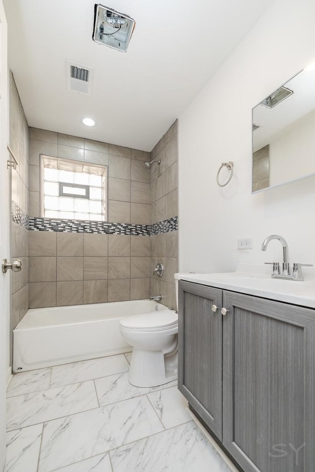 bathroom featuring vanity, toilet, shower / washtub combination, marble finish floor, and visible vents