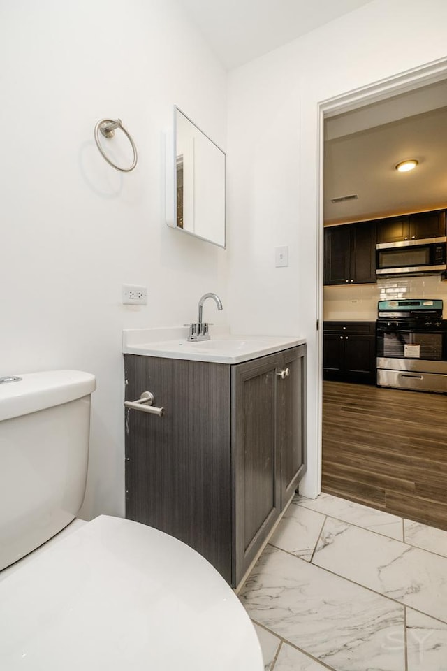 bathroom with vanity, tasteful backsplash, toilet, marble finish floor, and visible vents