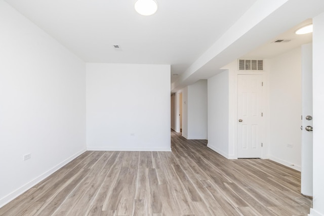 spare room with light wood finished floors, baseboards, and visible vents