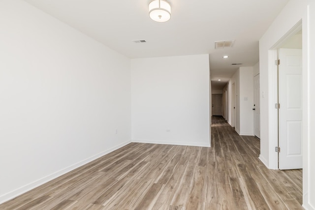 spare room featuring recessed lighting, baseboards, light wood-style floors, and visible vents