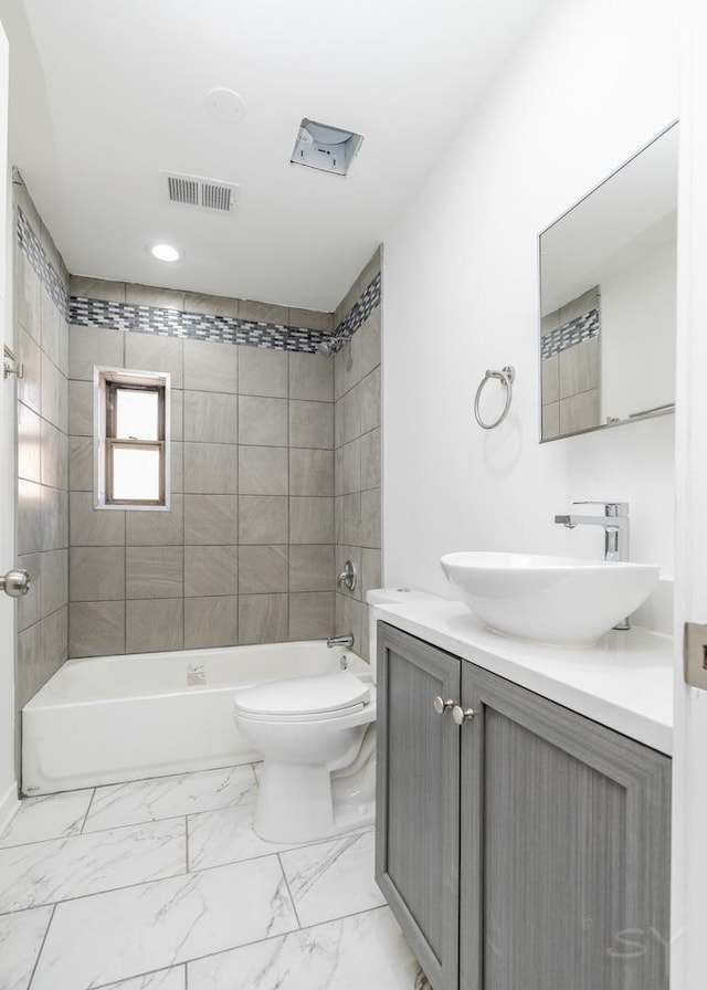 full bathroom with toilet, vanity,  shower combination, marble finish floor, and visible vents