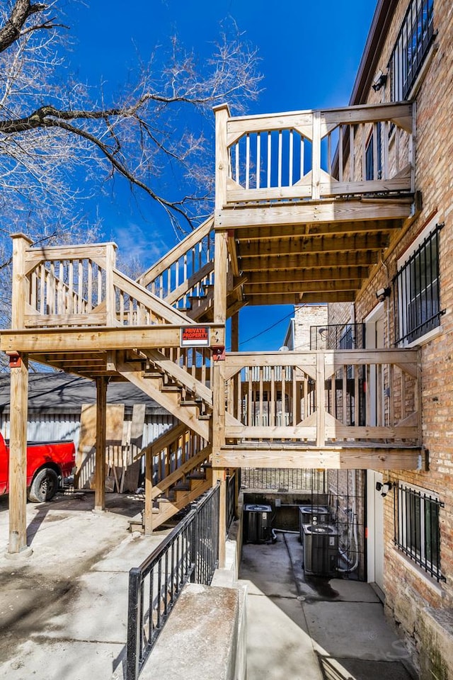 view of patio / terrace featuring central air condition unit and stairway