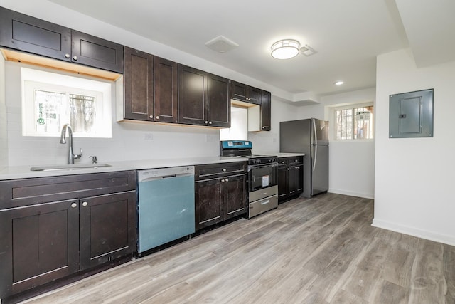 kitchen featuring electric panel, a sink, freestanding refrigerator, dishwasher, and gas range oven