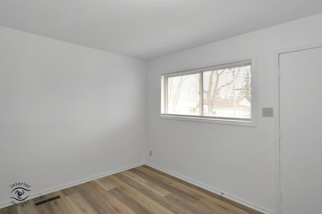 22426 Yates Ave, Sauk Village, IL 60411 - empty room featuring baseboards, visible vents, and wood finished floors