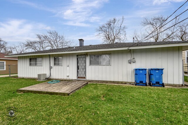 22426 Yates Ave, Sauk Village, IL 60411 - rear view of house featuring fence, board and batten siding, central AC unit, a yard, and a chimney