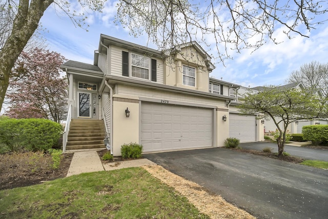 2470 Palazzo Ct, Buffalo Grove, IL 60089 - view of front of home featuring stucco siding, aphalt driveway, and a garage