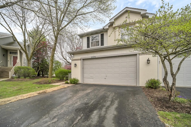 2470 Palazzo Ct, Buffalo Grove, IL 60089 - view of front of home featuring stucco siding, driveway, and a garage