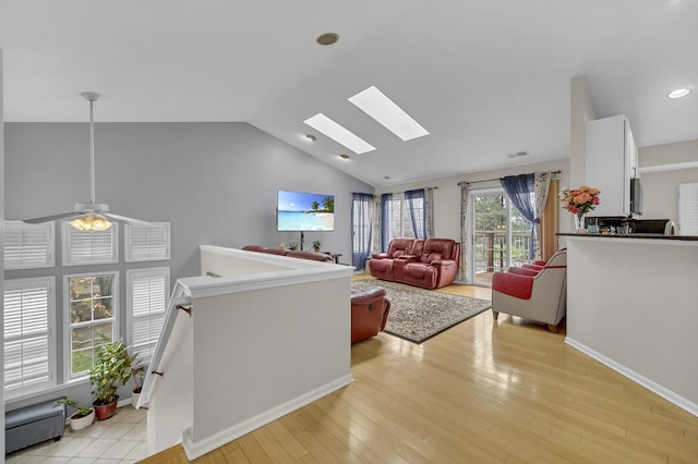 2470 Palazzo Ct, Buffalo Grove, IL 60089 - living area featuring vaulted ceiling with skylight, baseboards, light wood-style flooring, and visible vents