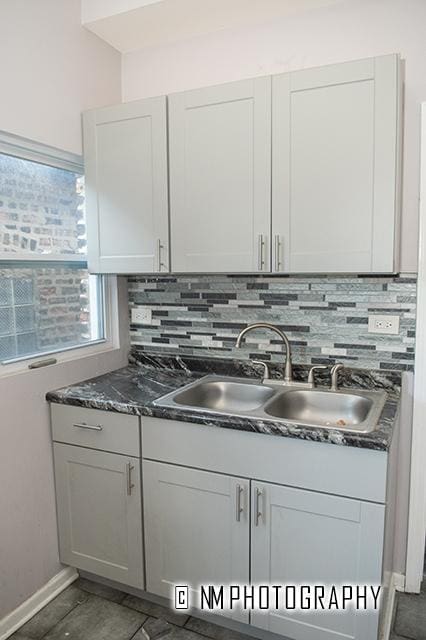 2152 W 19th St, Chicago, IL 60608 - kitchen featuring dark countertops, tasteful backsplash, and a sink