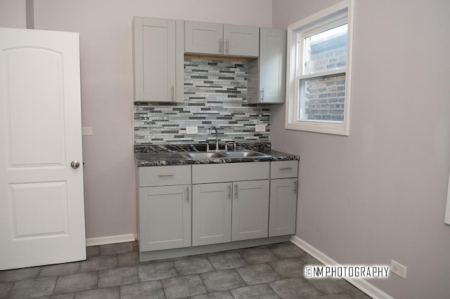 2152 W 19th St, Chicago, IL 60608 - kitchen with baseboards, backsplash, a sink, dark countertops, and visible vents