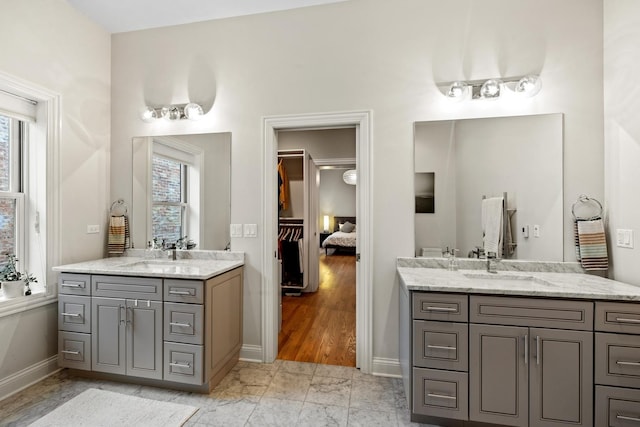 5486 S Woodlawn Ave Unit 3, Chicago, IL 60615 - bathroom with plenty of natural light, a sink, and two vanities