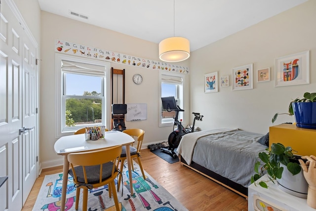 5486 S Woodlawn Ave Unit 3, Chicago, IL 60615 - bedroom featuring baseboards, visible vents, multiple windows, and light wood-type flooring