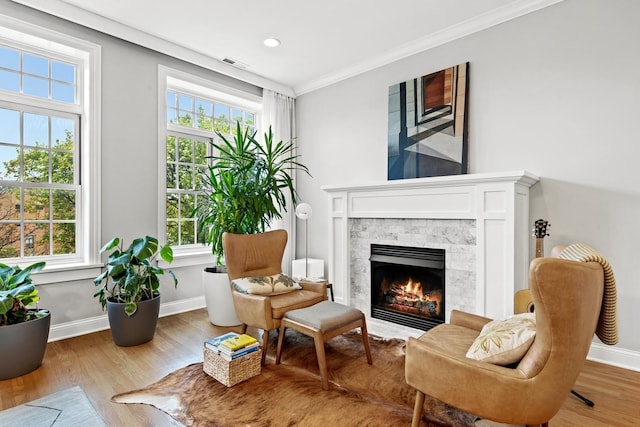 5486 S Woodlawn Ave Unit 3, Chicago, IL 60615 - living area with ornamental molding, baseboards, visible vents, a stone fireplace, and wood finished floors