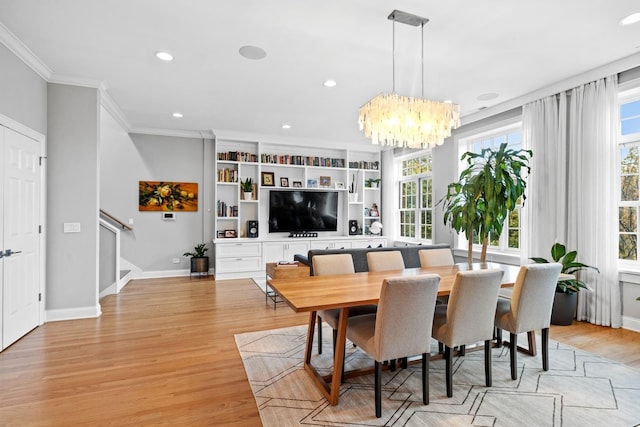 5486 S Woodlawn Ave Unit 3, Chicago, IL 60615 - dining room with plenty of natural light, a notable chandelier, light wood-style floors, and ornamental molding
