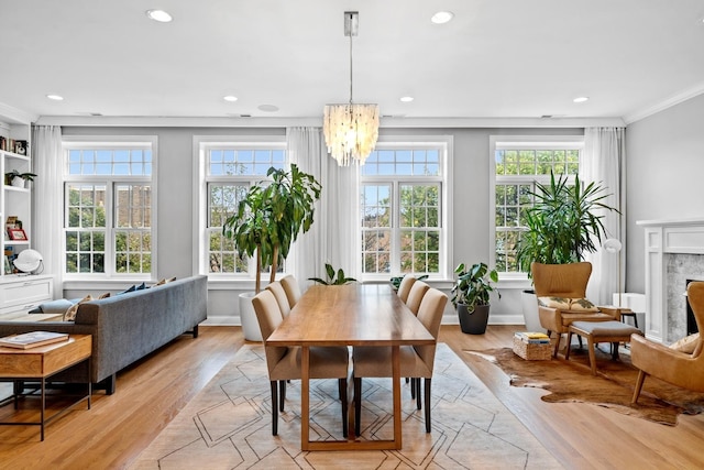 5486 S Woodlawn Ave Unit 3, Chicago, IL 60615 - dining area featuring a fireplace, light wood-style floors, recessed lighting, and a chandelier