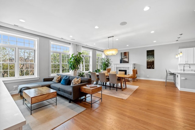5486 S Woodlawn Ave Unit 3, Chicago, IL 60615 - living room featuring recessed lighting, baseboards, light wood-style floors, visible vents, and a fireplace