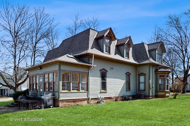 view of home's exterior featuring a lawn and roof with shingles