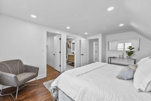 bedroom with baseboards, recessed lighting, connected bathroom, vaulted ceiling, and wood finished floors
