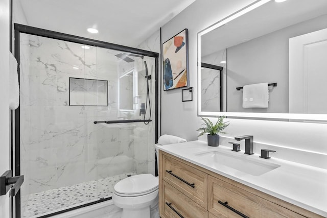 bathroom featuring toilet, recessed lighting, vanity, a marble finish shower, and marble finish floor