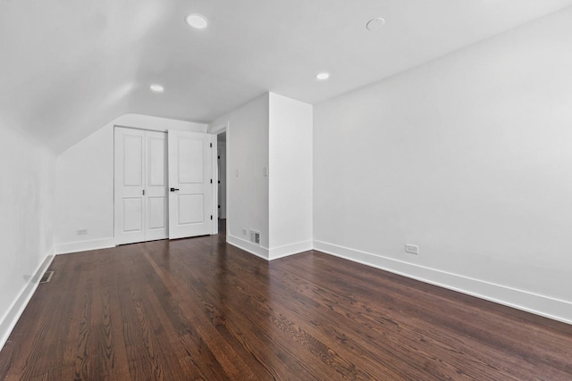bonus room with recessed lighting, baseboards, vaulted ceiling, and dark wood finished floors