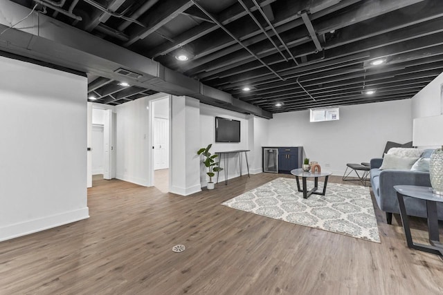 basement with wood finished floors, baseboards, and visible vents