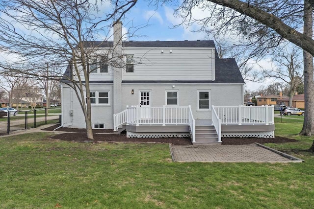 rear view of house with a yard, a patio area, fence, a chimney, and a deck