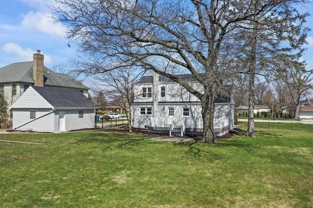back of property with a lawn