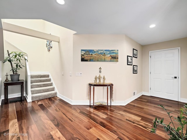 foyer entrance with recessed lighting, wood finished floors, baseboards, and stairway
