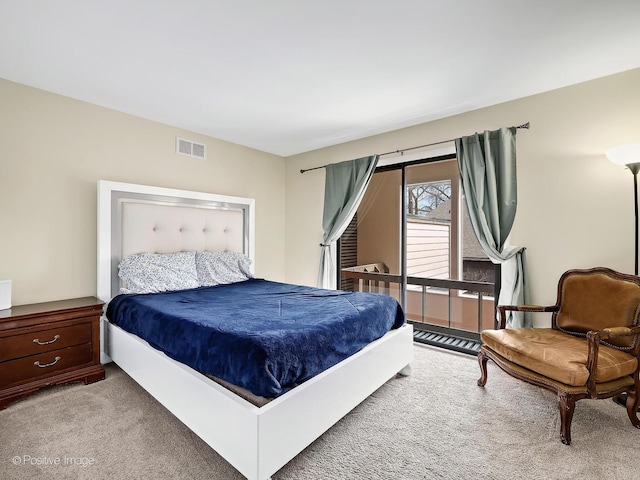 carpeted bedroom featuring visible vents