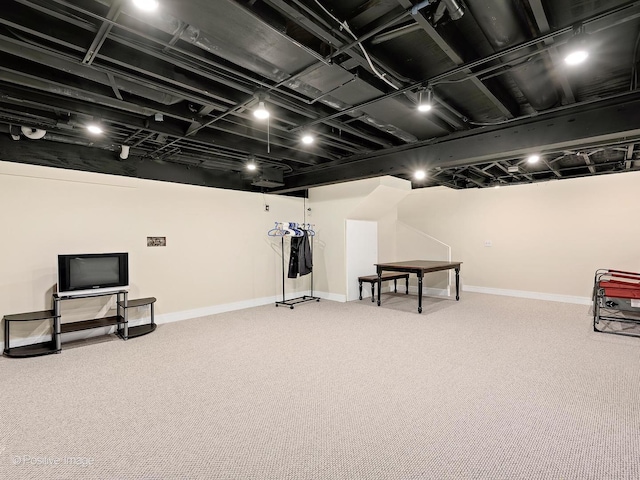 basement with baseboards and carpet flooring