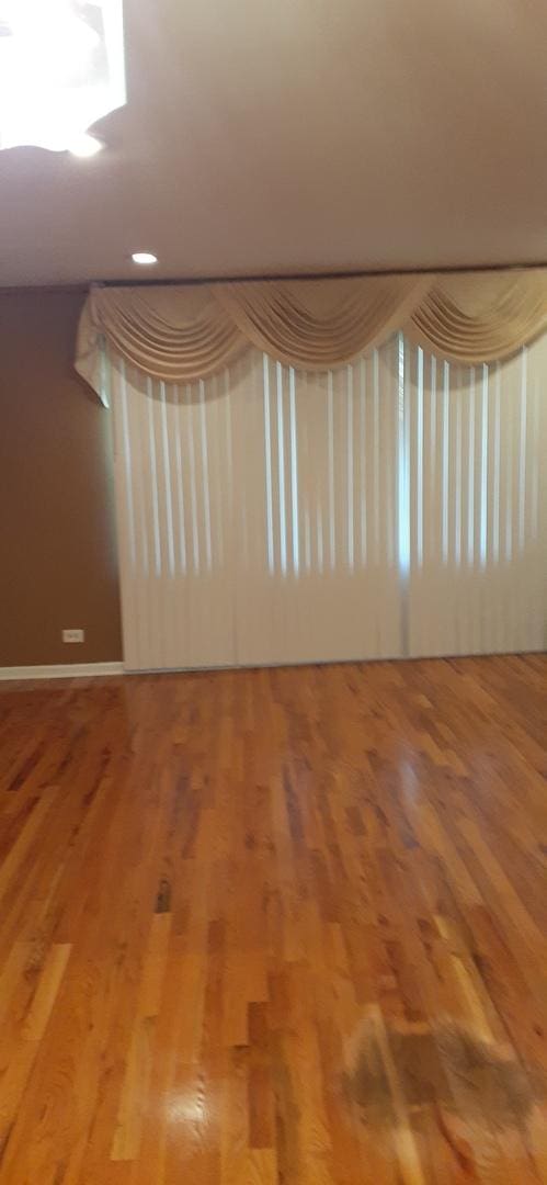15831 Dante Dr, South Holland, IL 60473 - spare room featuring wood finished floors and baseboards