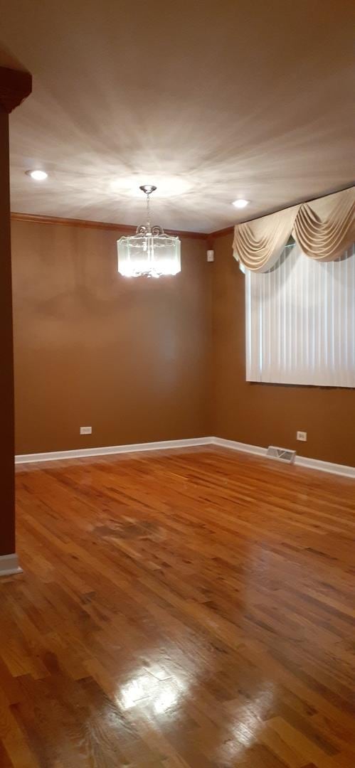 15831 Dante Dr, South Holland, IL 60473 - spare room featuring wood finished floors, baseboards, a chandelier, recessed lighting, and ornamental molding