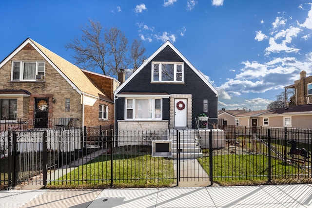 view of front of home with stone siding, a fenced front yard, and a front yard