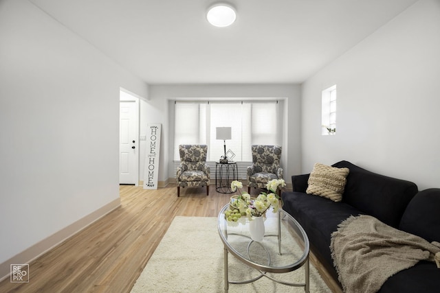 living room featuring baseboards and light wood-style floors
