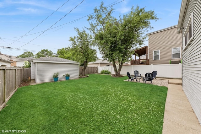 6317 W Roscoe St, Chicago, IL 60634 - fenced backyard with a fire pit and an outdoor structure