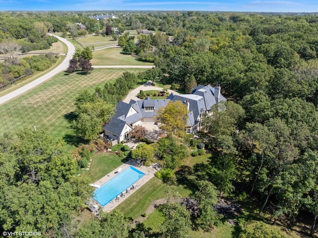 birds eye view of property with a wooded view