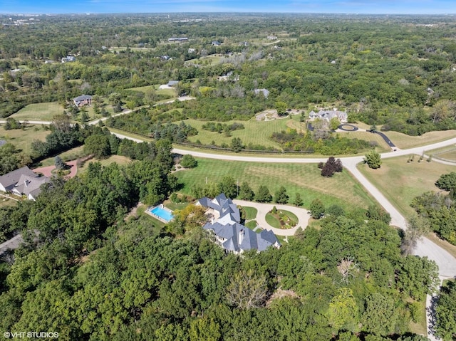 birds eye view of property featuring a wooded view