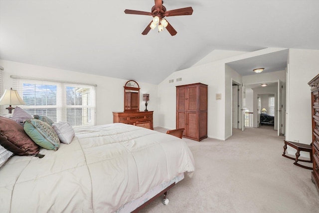 bedroom featuring ceiling fan, lofted ceiling, light colored carpet, and visible vents