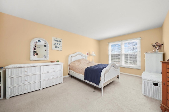 bedroom featuring carpet and baseboards