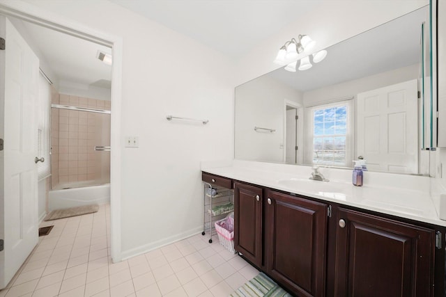 bathroom with baseboards, combined bath / shower with glass door, tile patterned floors, and vanity