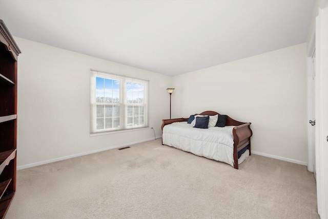 carpeted bedroom with baseboards and visible vents