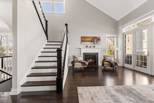 104 W Kennedy Ln, Hinsdale, IL 60521 - foyer with high vaulted ceiling, a warm lit fireplace, stairs, wood finished floors, and baseboards