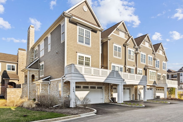 104 W Kennedy Ln, Hinsdale, IL 60521 - view of front facade with an attached garage, driveway, stone siding, and a residential view