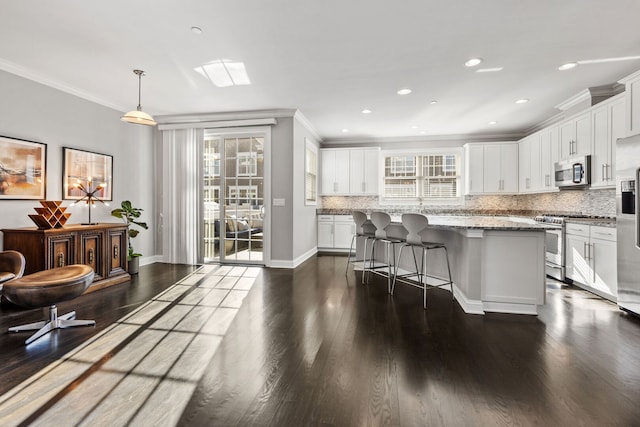 104 W Kennedy Ln, Hinsdale, IL 60521 - kitchen with appliances with stainless steel finishes, crown molding, dark wood-style floors, white cabinetry, and backsplash