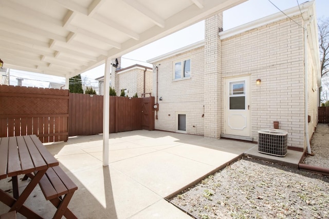 view of patio / terrace with central air condition unit and fence