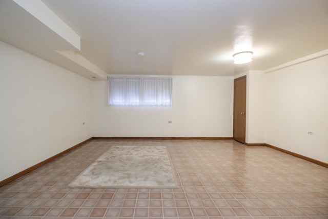 spare room with baseboards
