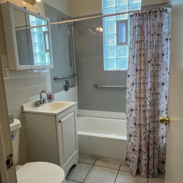 7417 S Saint Lawrence Ave, Chicago, IL 60619 - full bathroom with vanity, tile patterned floors, shower / bath combination with curtain, toilet, and tile walls