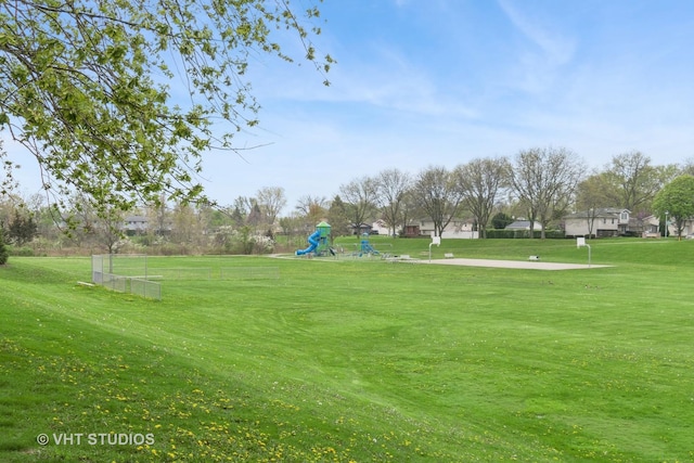 view of home's community with a yard and playground community