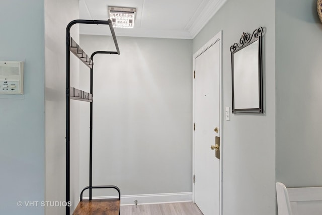 interior space featuring crown molding and wood finished floors